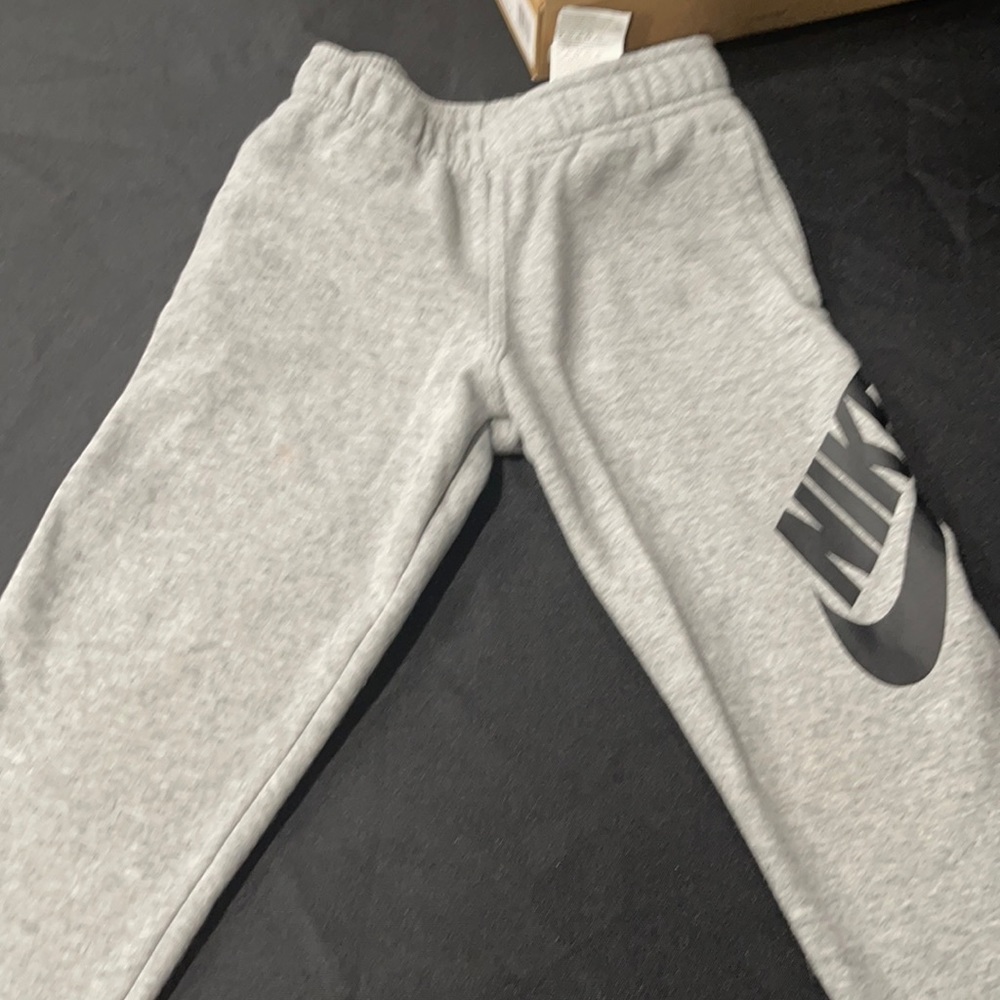 Grey Nike sweatpants with black logo size 6-7 years